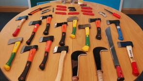 Police seize a large number of weapons and three men arrested following disturbances at a funeral this morning