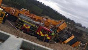 Emergency crews respond after a crane being used on main Derry to Belfast road project topples over 