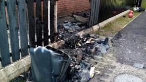 Bins set on fire beside a house in Derry's Creggan estate
