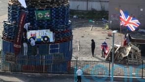Placing of flags and images on nationalist bonfire condemned