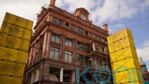 Facade of landmark city centre building begins to emerge