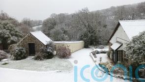 Snow sweeps in as cold snap continues