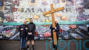 Communities unite to form human chain at peace wall to mark accord’s anniversary