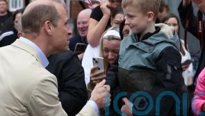 William jokes he’ll get into trouble as he hugs well-wishers in east Belfast