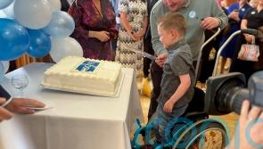 Daithi Mac Gabhann cuts cake on 75th anniversary of health service