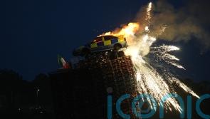 Mock police car burned on top of bonfire