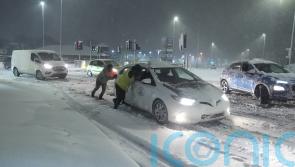 Heavy snow causes travel disruption across UK as amber warnings remain
