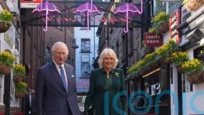 Charles and Camilla commence NI visit with sea shanties and acrobatics