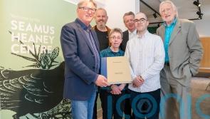 Adrian Dunbar gives rare art book to the Seamus Heaney Centre