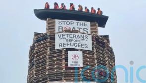 Calls for removal of migrant effigies in boat placed on loyalist bonfire in NI