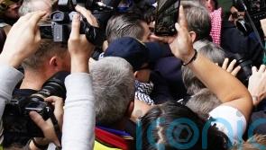Hundreds greet Kneecap rapper as he arrives at court on terror charge