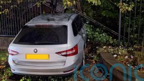 Officers injured after car rammed through fence