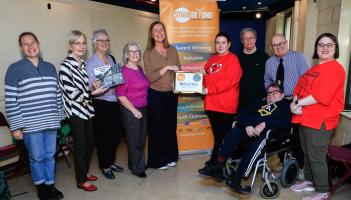 Yvonne Norris presenting donation to Bernie Shiels, chairperson, Stage Beyond. L-R: Becca Barnes, Mary Doherty, Sadie Harkin & Clare Moore, Susannah McKay, Frank Neils, Darren Bond & Kevin Harkin.