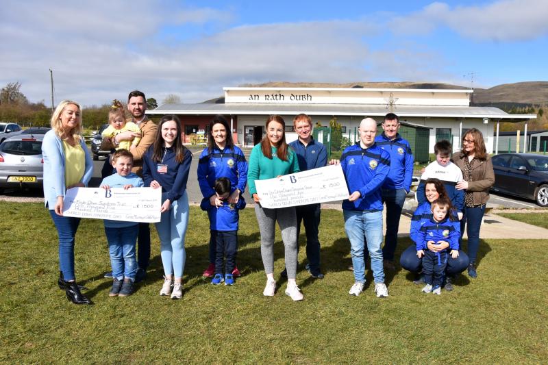 Cara and Orla hand over fundraising cheques