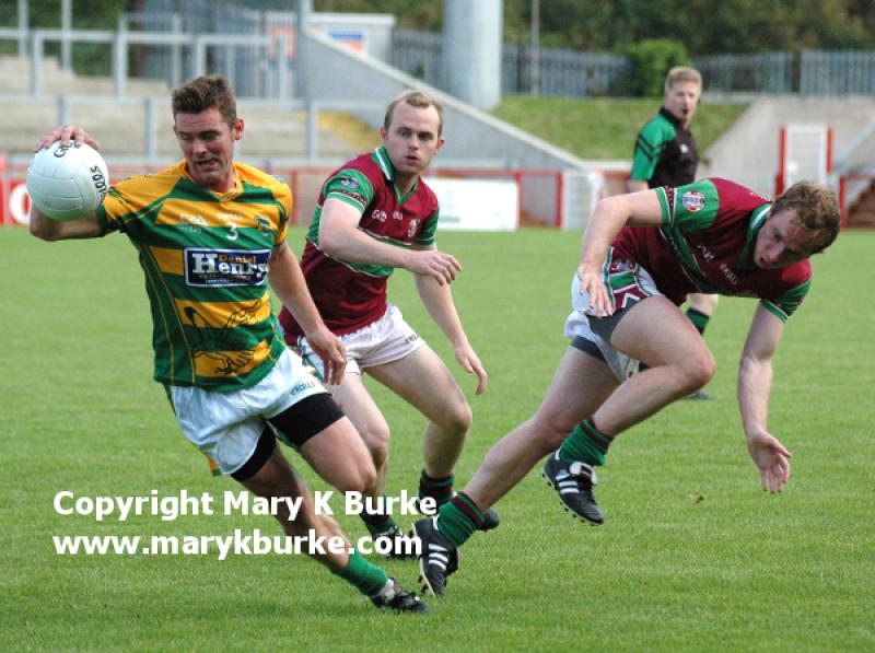 Brian Mullan turns away from Sean Leo and Ciaran McGoldrick