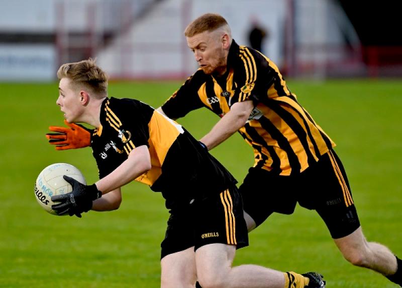 Doire Colmcille's Tiernan White spins past Ardmore defender Leonard Quinn.