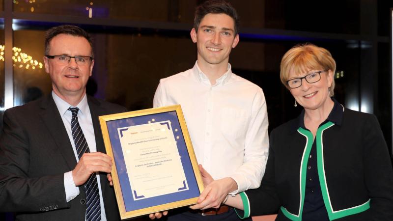Conal McGinley, UU School of Medicine Scholar receiving his award from Padraig Monaghan, Managing Director Optum Ireland and UK and Professor Terri Scott, Pro Vice Chancellor Ulster University.