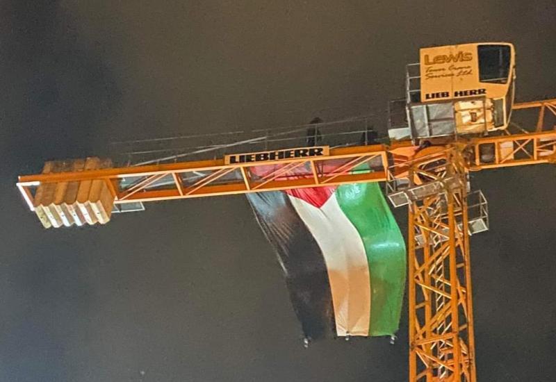 Three charged with disorderly behaviour after erecting large Palestinian flag on a crane