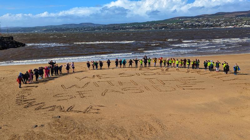 School children working together to keep Magilligan beach beautiful