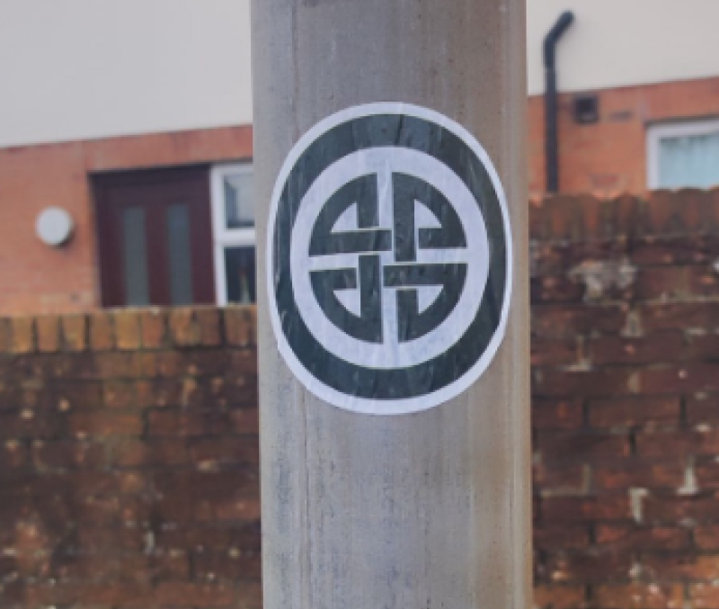 Image of the sticker; credit: United Against Racism—Derry and North West Facebook