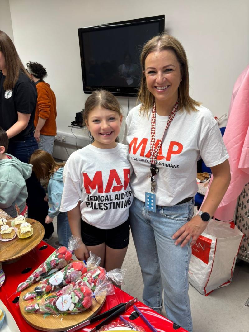 Sinead Hughes with her youngest daughter, Alannah at the Medical Aid for Palestine bake sale in Altagelvin.