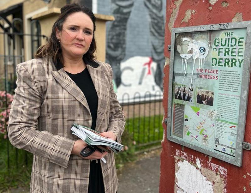 Sinn Féin Moor representative Aisling Hutton at one of the many signs along Rossville Street.