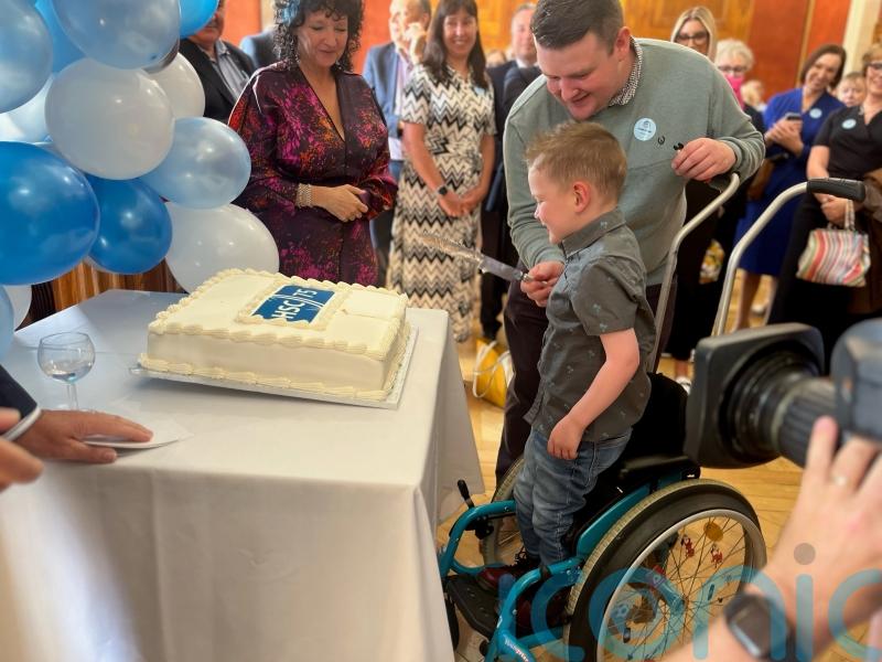 Daithi Mac Gabhann cuts cake on 75th anniversary of health service