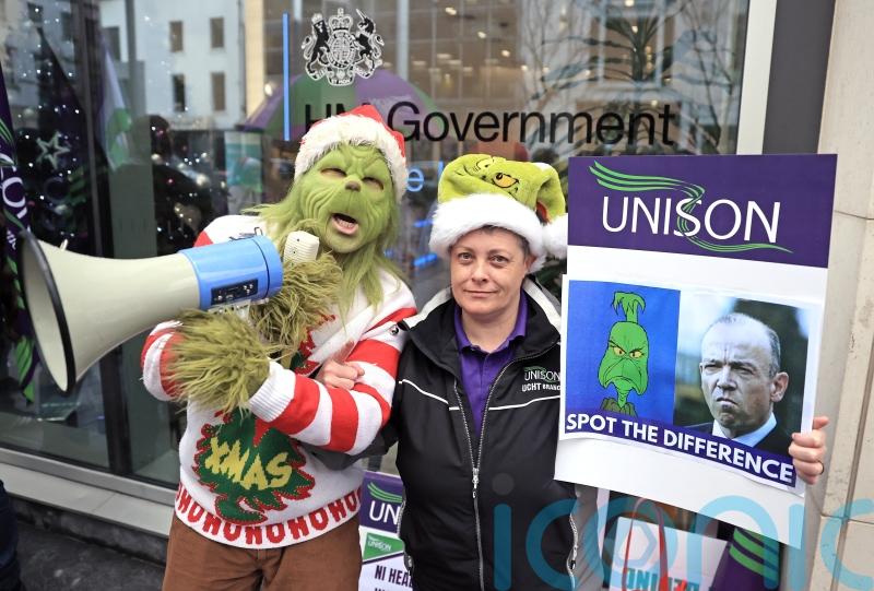 Health workers in Northern Ireland stage Grinch protest in pay dispute