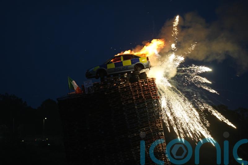 Mock police car burned on top of bonfire