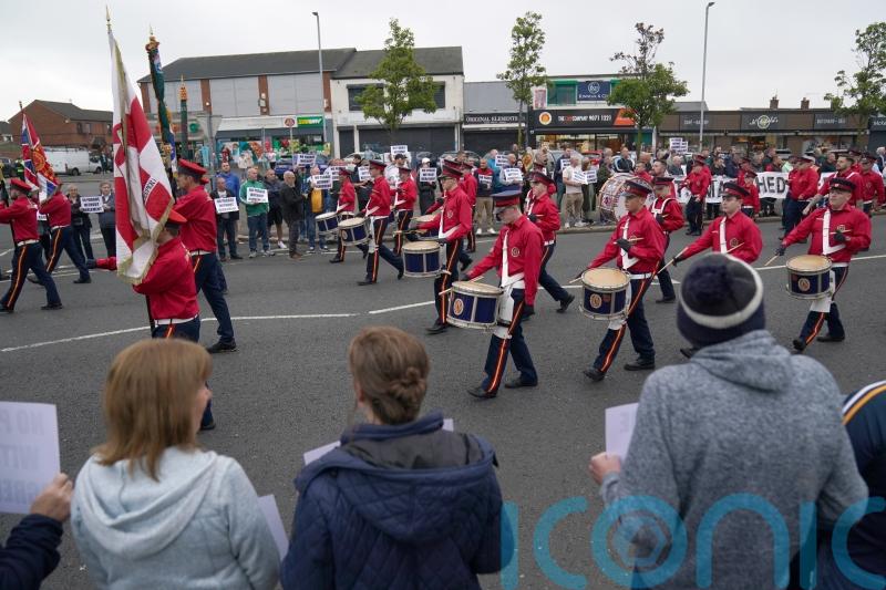 Orangemen parade passes by Ardoyne without incident as residents stage protest
