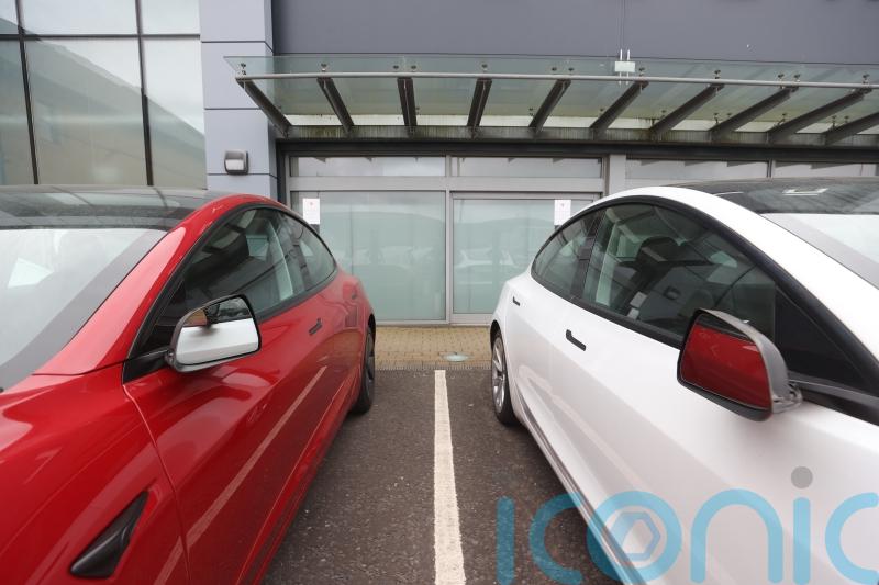Police investigate damage to cars at Tesla dealership
