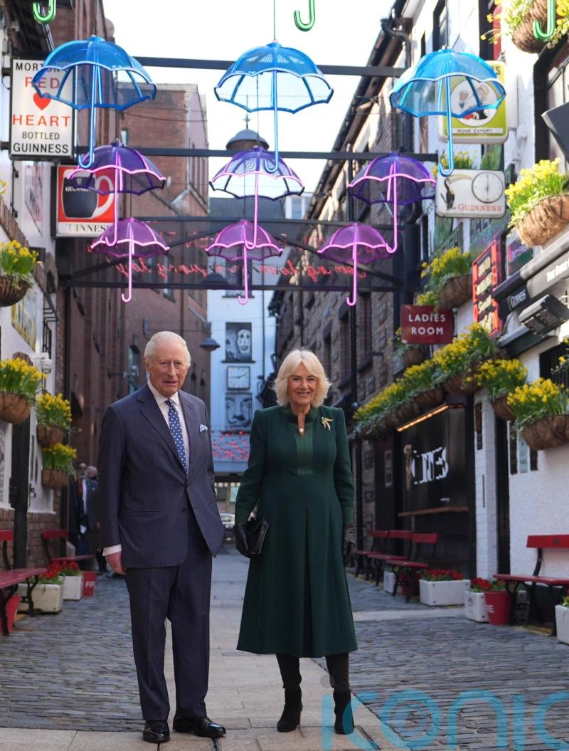 Charles and Camilla commence NI visit with sea shanties and acrobatics