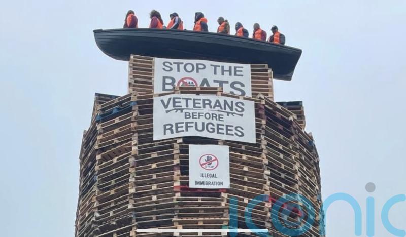 Calls for removal of migrant effigies in boat placed on loyalist bonfire in NI