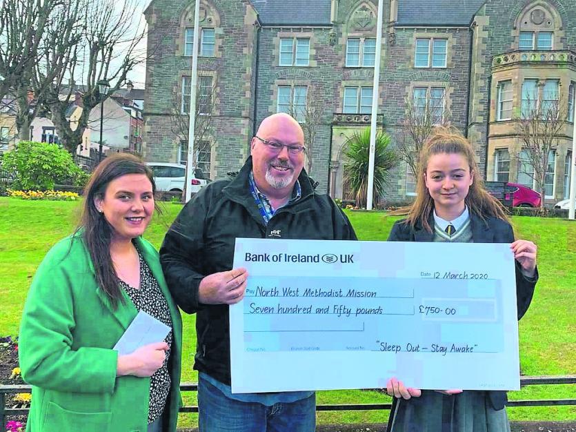 James Jennings from North West Methodist Mission  receives a cheque from Zara Schlindwein.