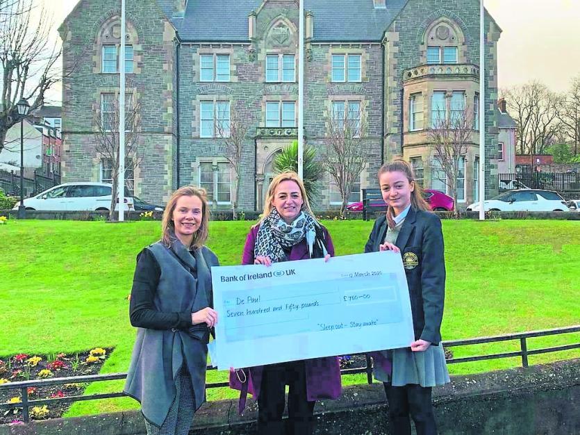 Ellen Harper from De Paul receives a cheque from Zara Schlindwein.