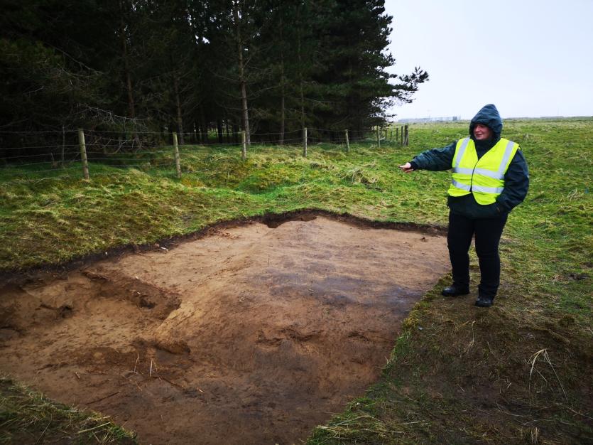 Dr Montogomery examines one of the dig sites at Magilligan. 