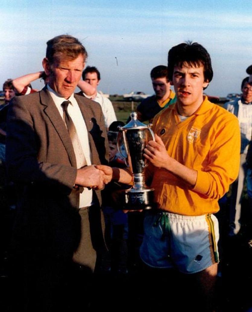 Willie Turner presents Glen captain Colin McKenna with the Larkin Cup in 1987, following their win over Slaugtneil at Swatragh