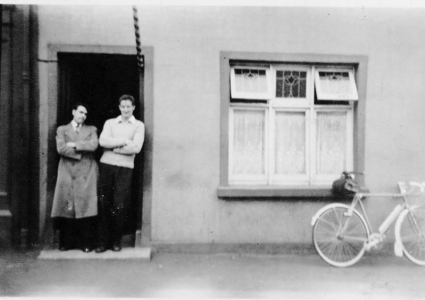 Seamus Doran pictured with a friend outside his barbers' shop in Dungiven.