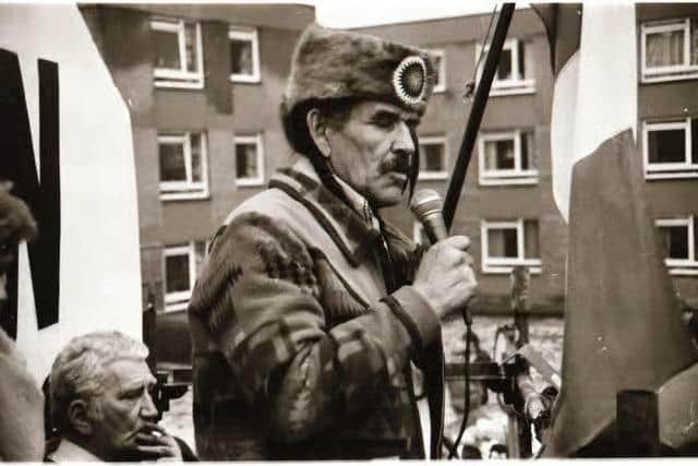 Ojibwe leader and founder of the American Indian Movement (AIM), Clyde 'The Thunder Before the Storm' Bellecourt, addressing the Bloody Sunday commemoration in 1985. Pictured on the left is the late Derry republican Seán Keenan