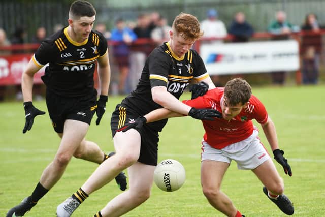 Niall Friel, Sean Dolan's, tangles with Doire Colmcille defender Callum Dunnion.